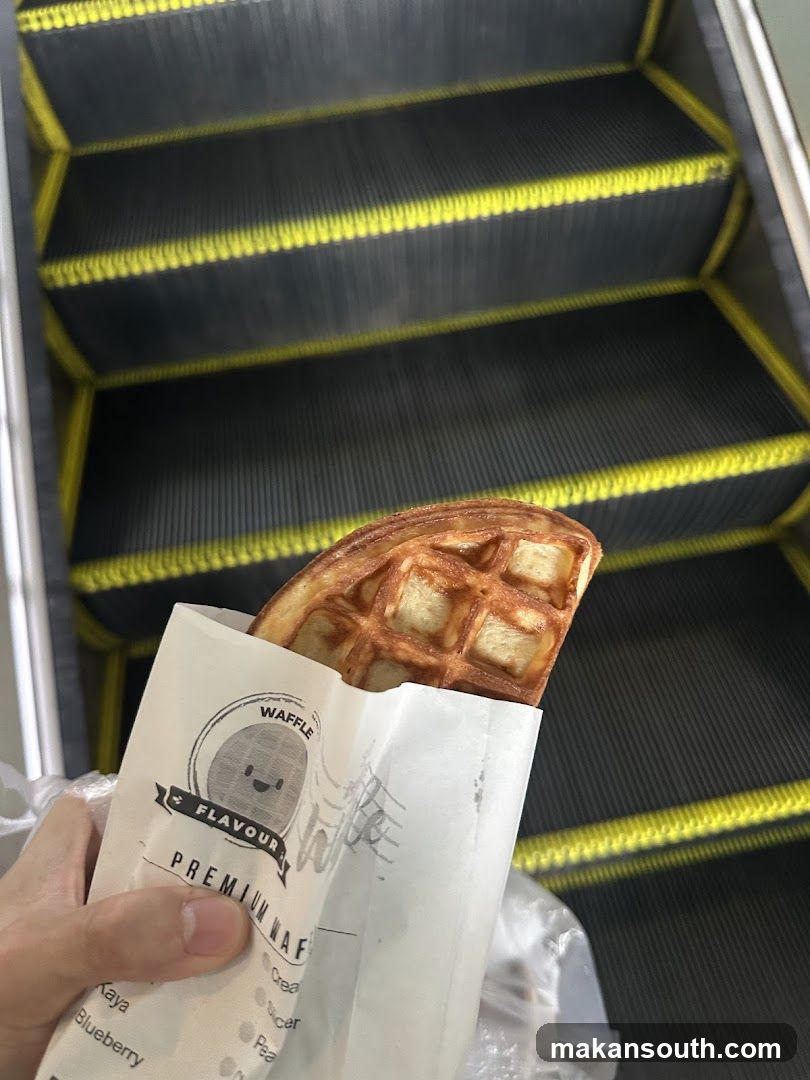 Waffle in hand near escalator