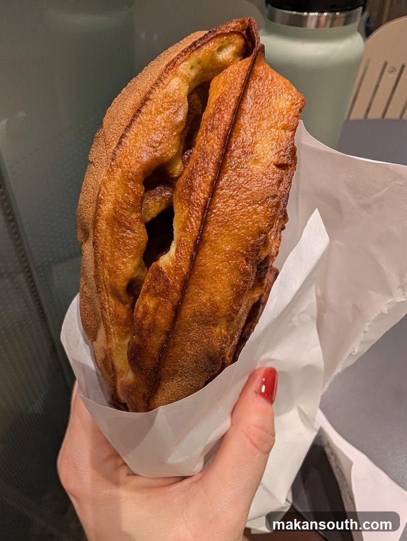 Hand Holding a Waffle Sandwich