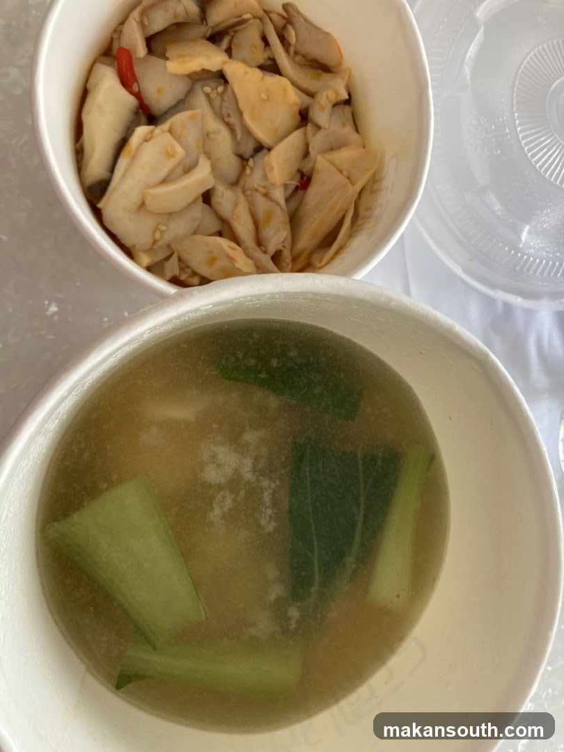 Food bowls with soup and pickled items