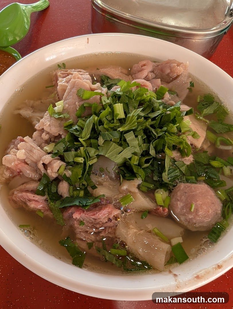 Bowl of Meat Soup with Herbs