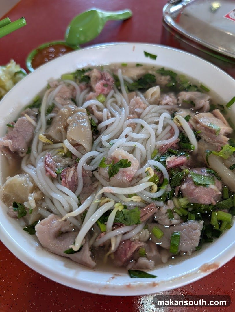 Bowl of Noodle Soup with Meat and Greens