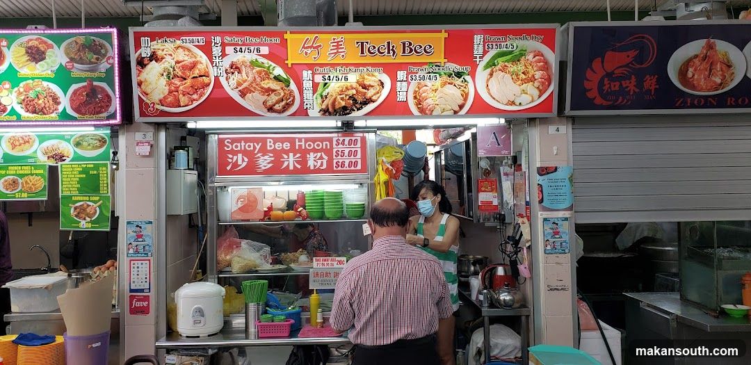 Food Stall Interior with Staff and Customer