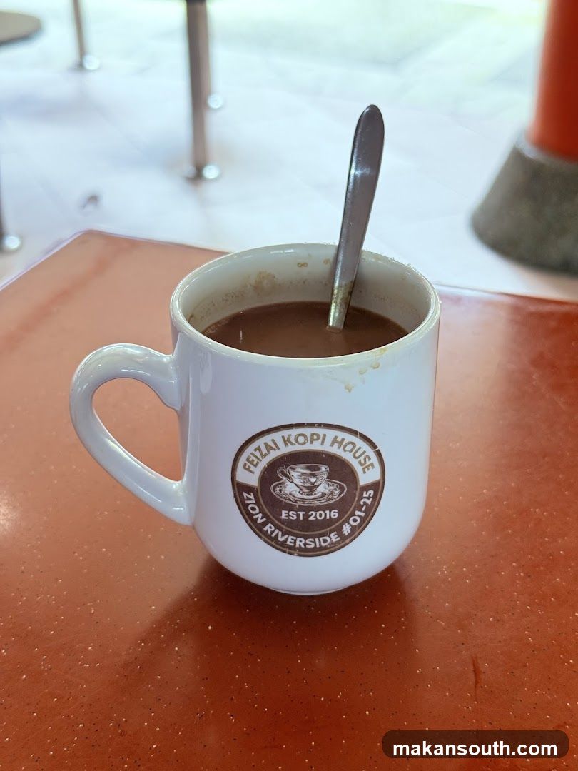 Kopi in a branded mug