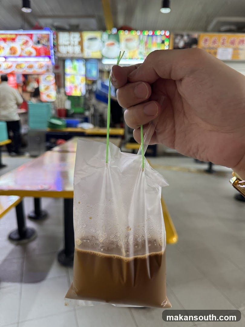 Hand holding a bag of coffee in food court