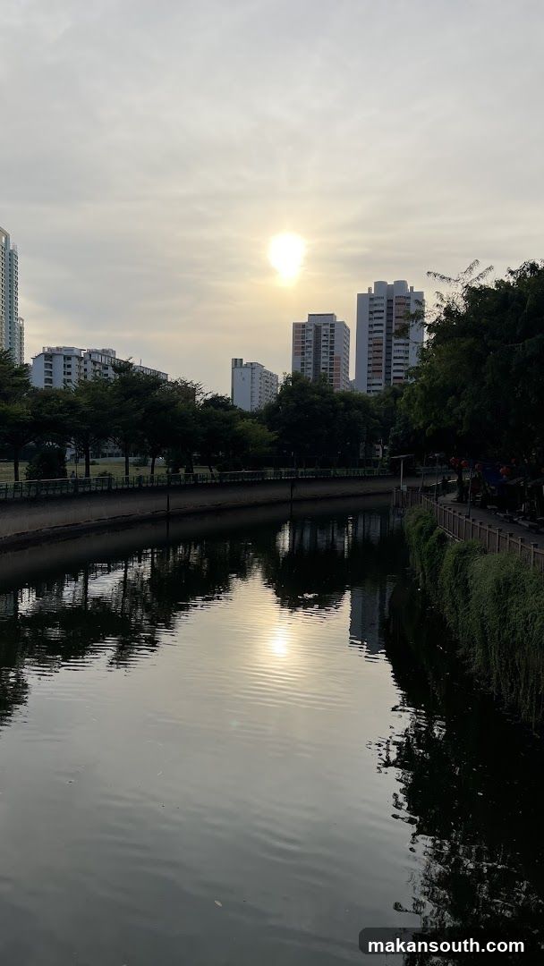 Sunset over canal with high-rise buildings