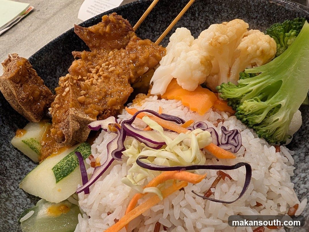 Bowl of Rice with Vegetables and Meat Skewers