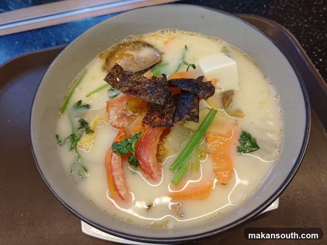 Bowl of Creamy Soup with Tofu and Vegetables