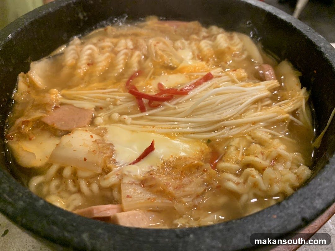 Korean-style hot pot with noodles and kimchi