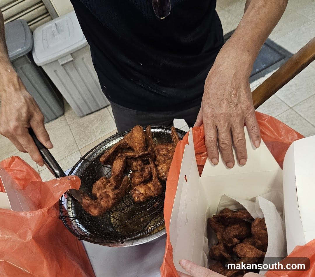 Fried Chicken Being Packaged