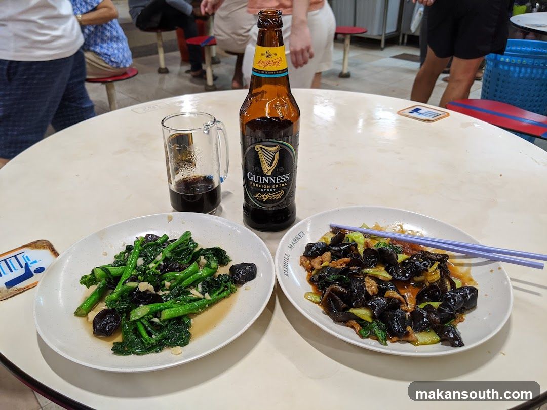 Guinness Beer and Chinese Dishes at a Restaurant Table
