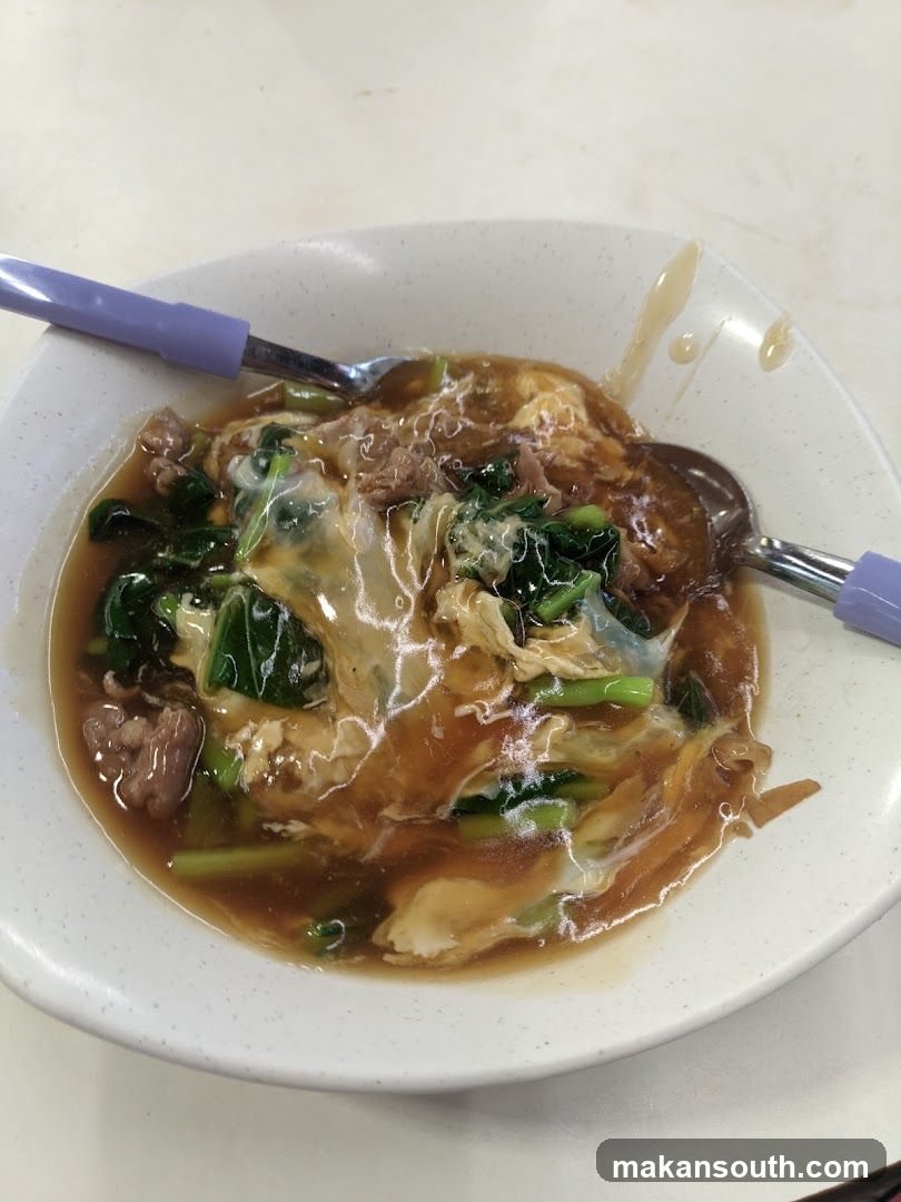 Bowl of Noodle Soup with Egg and Greens