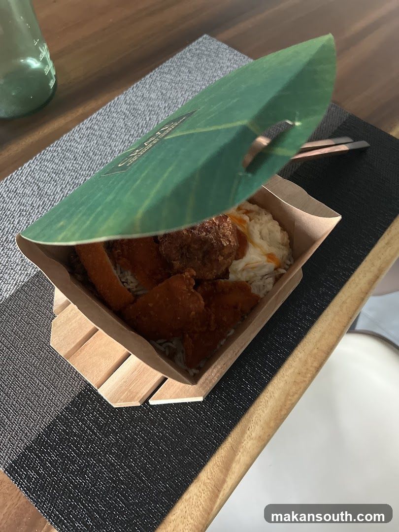 Food in a paper container with leaf lid