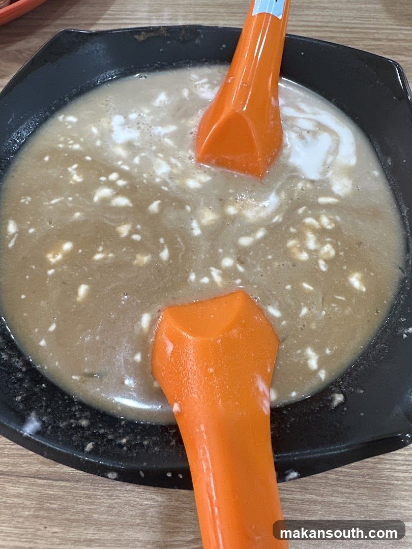 Bowl of Soup with Spoons