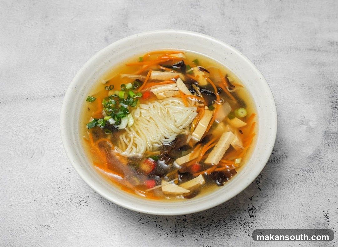 Bowl of Noodle Soup with Vegetables and Tofu