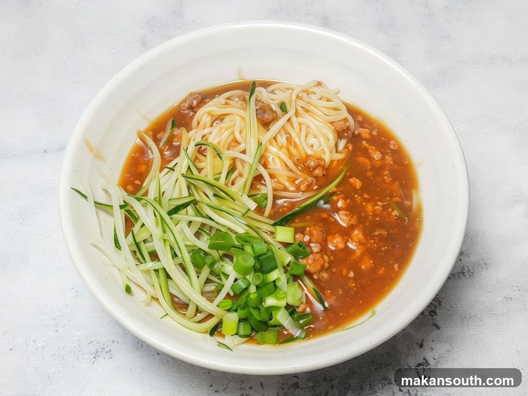 Bowl of Noodles with Sauce and Garnish