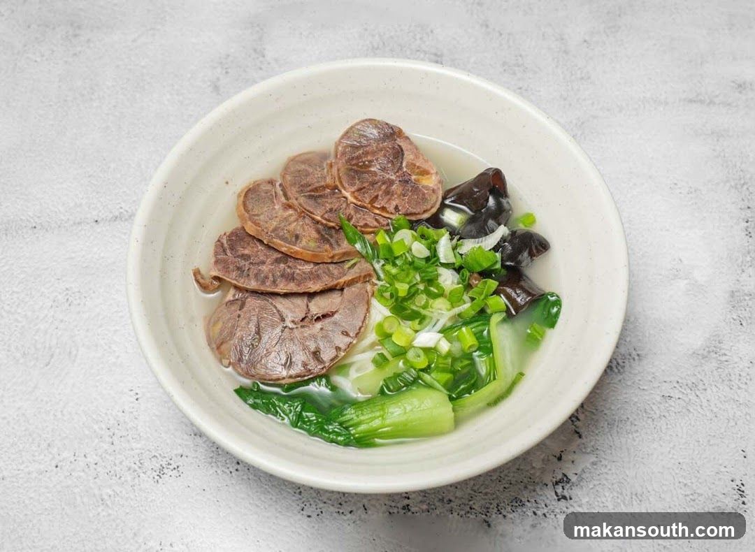Bowl of Noodle Soup with Meat and Vegetables