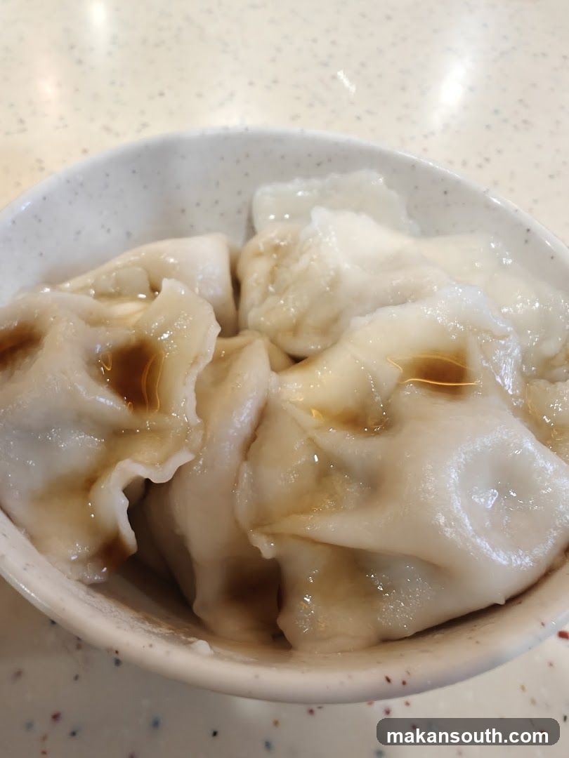 Bowl of Steamed Dumplings with Soy Sauce