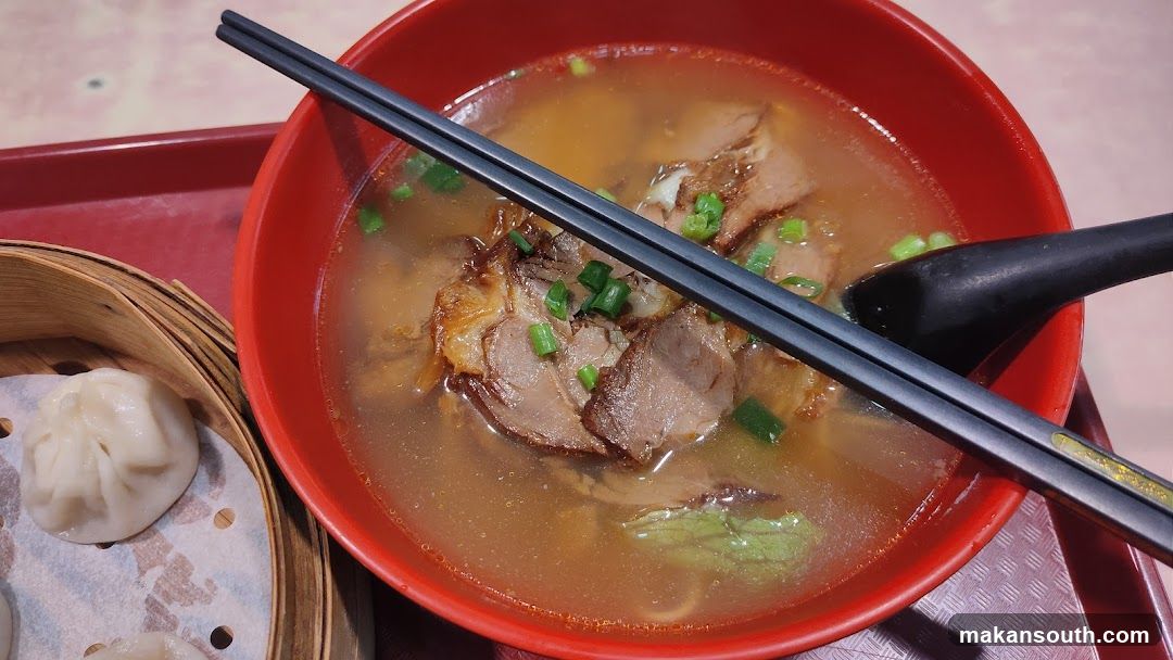 Bowl of soup with chopsticks and dumplings