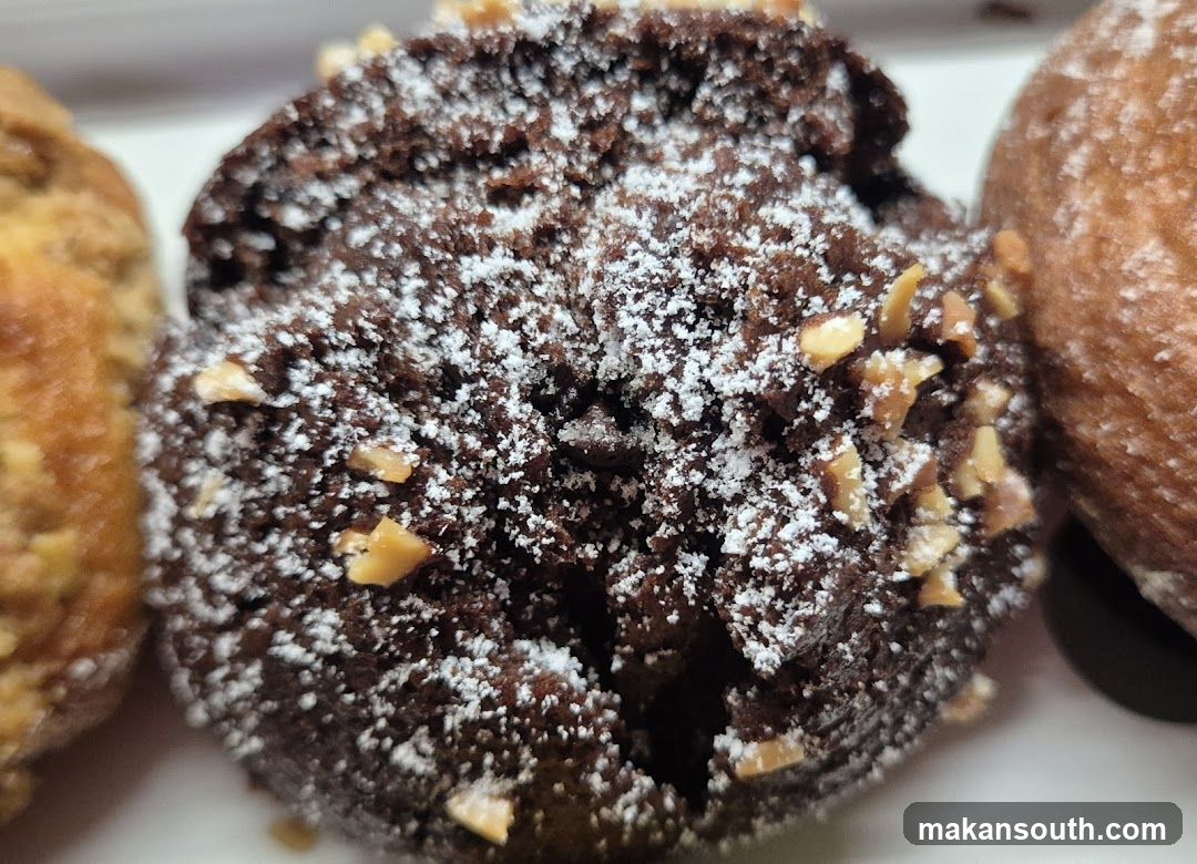 Chocolate Donut with Powdered Sugar and Nuts