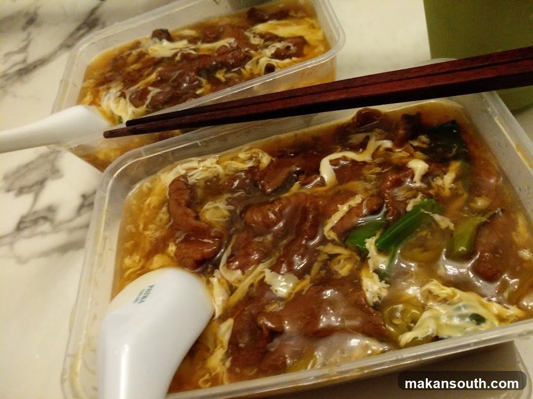 Takeout Bowls of Noodle Soup with Meat and Egg