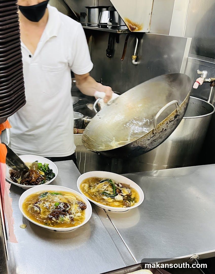 Chef preparing noodles in kitchen