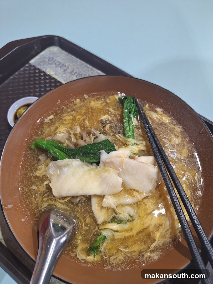Bowl of Noodle Soup with Chopsticks and Spoon
