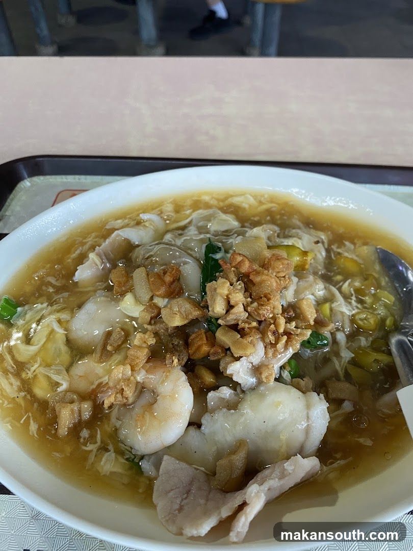 Bowl of Noodle Soup with Shrimp and Crispy Toppings