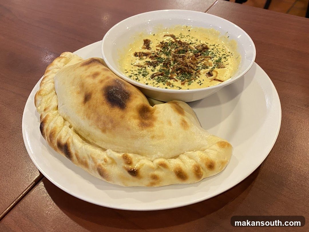 Handheld pastry with soup