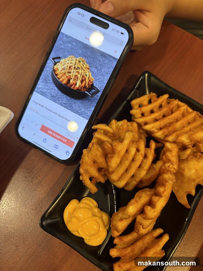 Waffle fries and phone showing food app