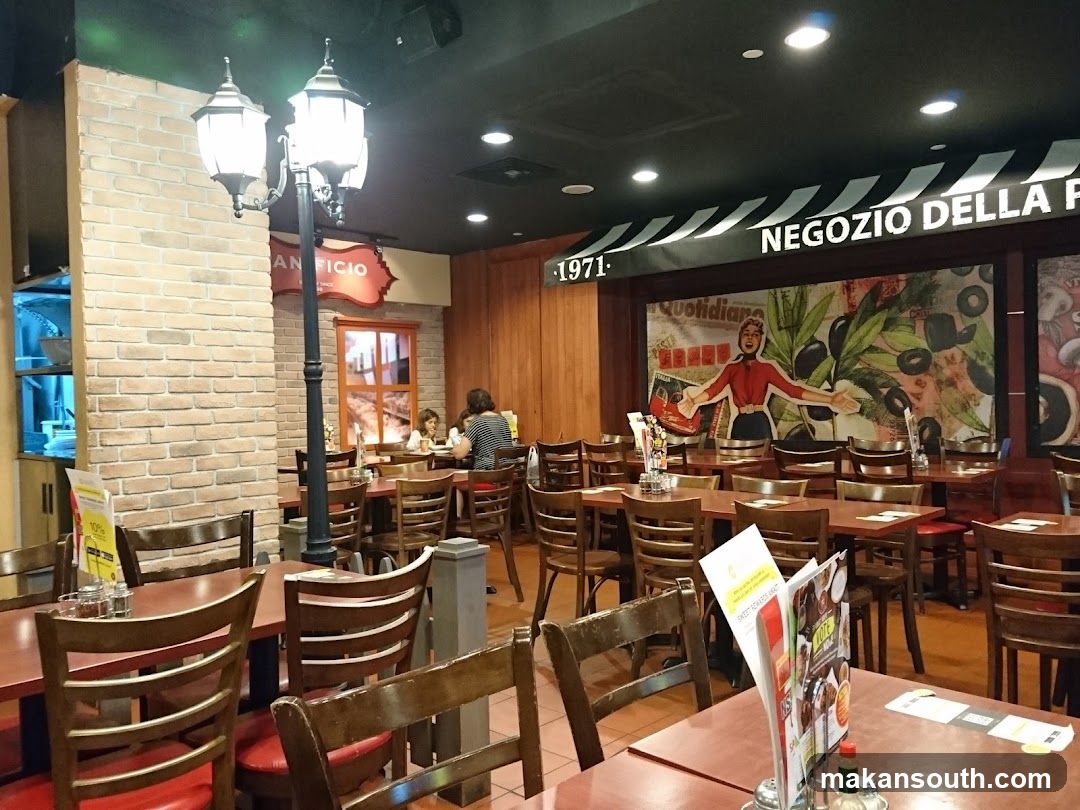 Interior of a restaurant with wooden furniture and brick walls