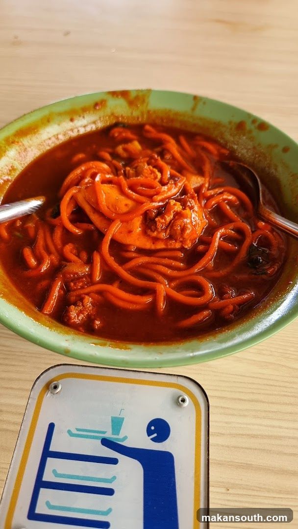 Bowl of Spicy Noodles with Sign