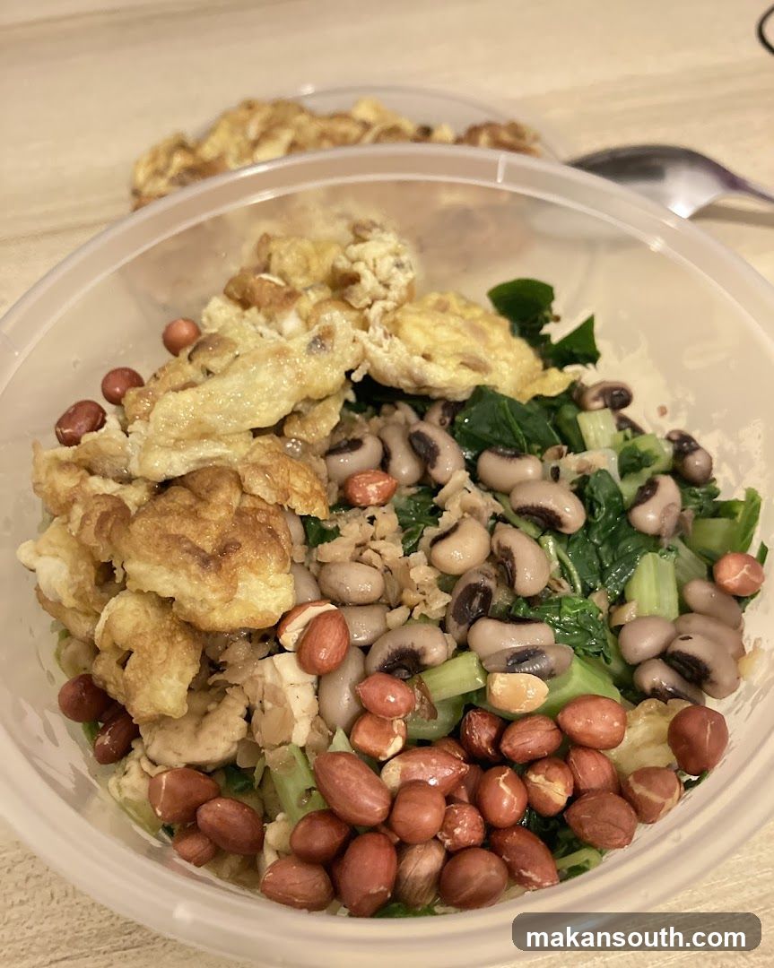 Bowl of food with eggs, beans, and greens