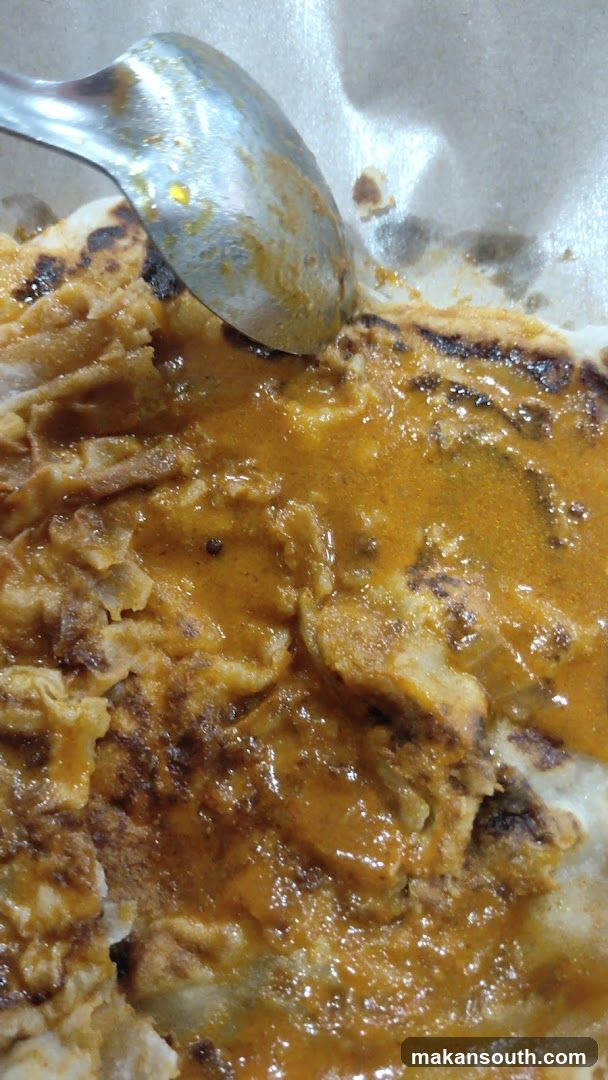 Spicy Curry Dish with Spoon