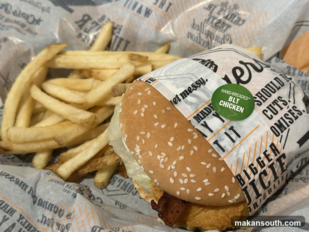 Burger and fries in branded paper
