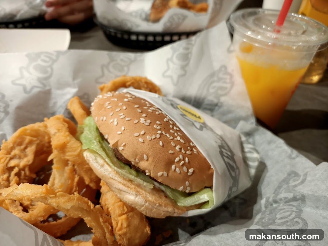 Burger and Onion Rings with Orange Drink