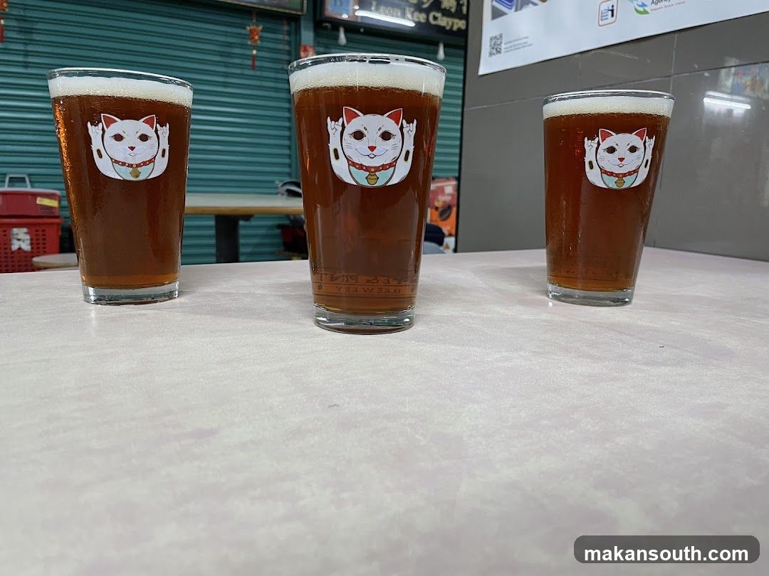 Three glasses of beer with Maneki-neko design