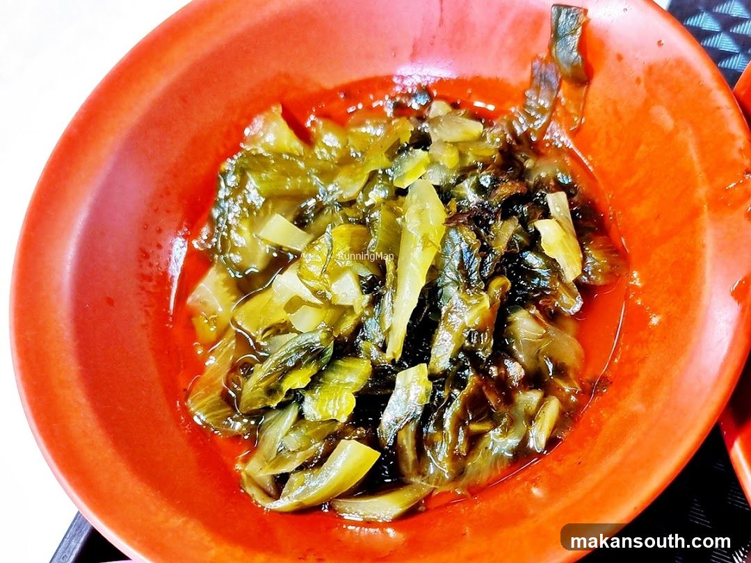 Bowl of pickled vegetables in red dish