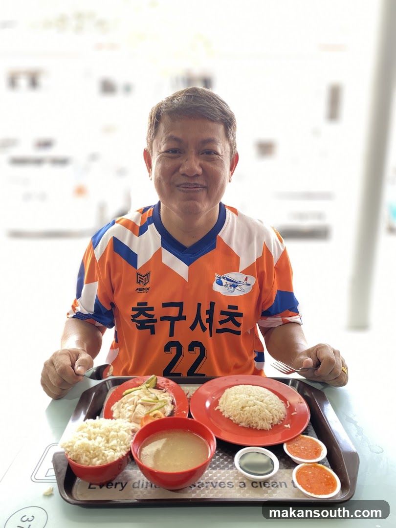 Man in Soccer Jersey with Meal Tray