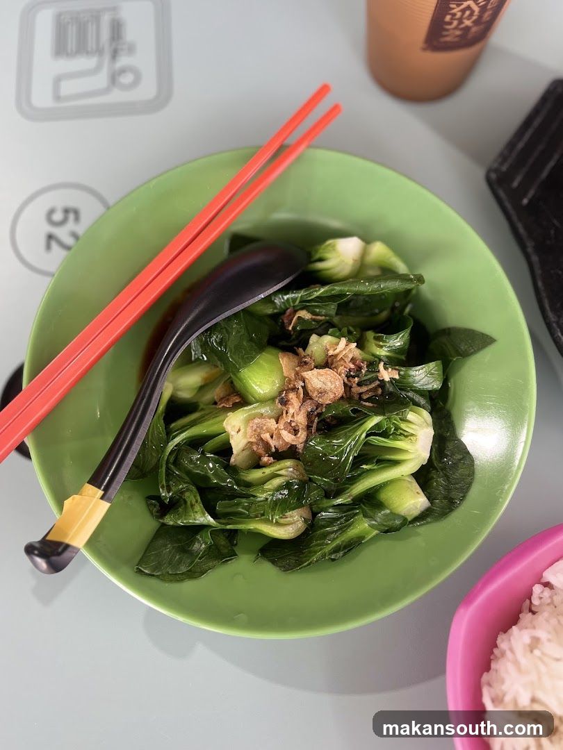 Bowl of stir-fried greens with fried garlic