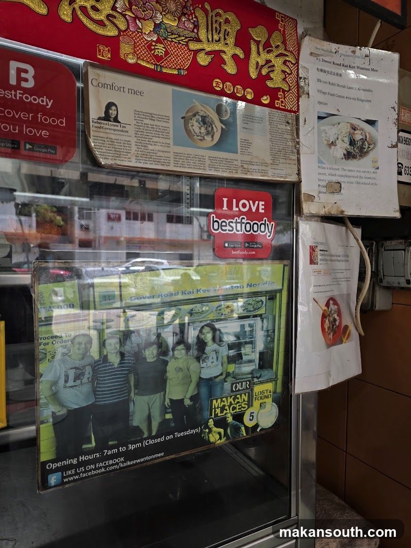 Food stall display case with posters and flyers