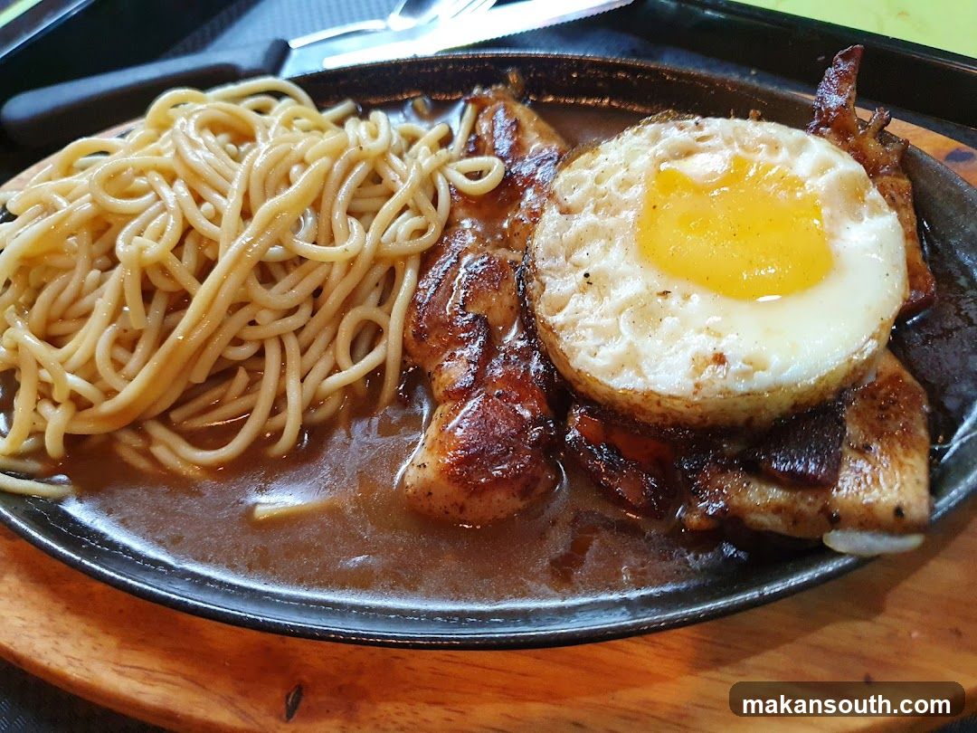 Sizzling Plate with Noodles and Fried Egg