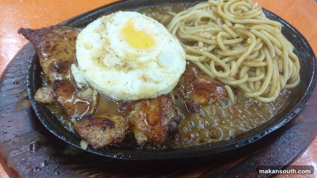 Sizzling Plate with Fried Egg and Noodles