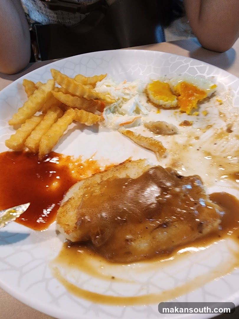 Plate of Food with Fries, Sauce, and Fried Egg