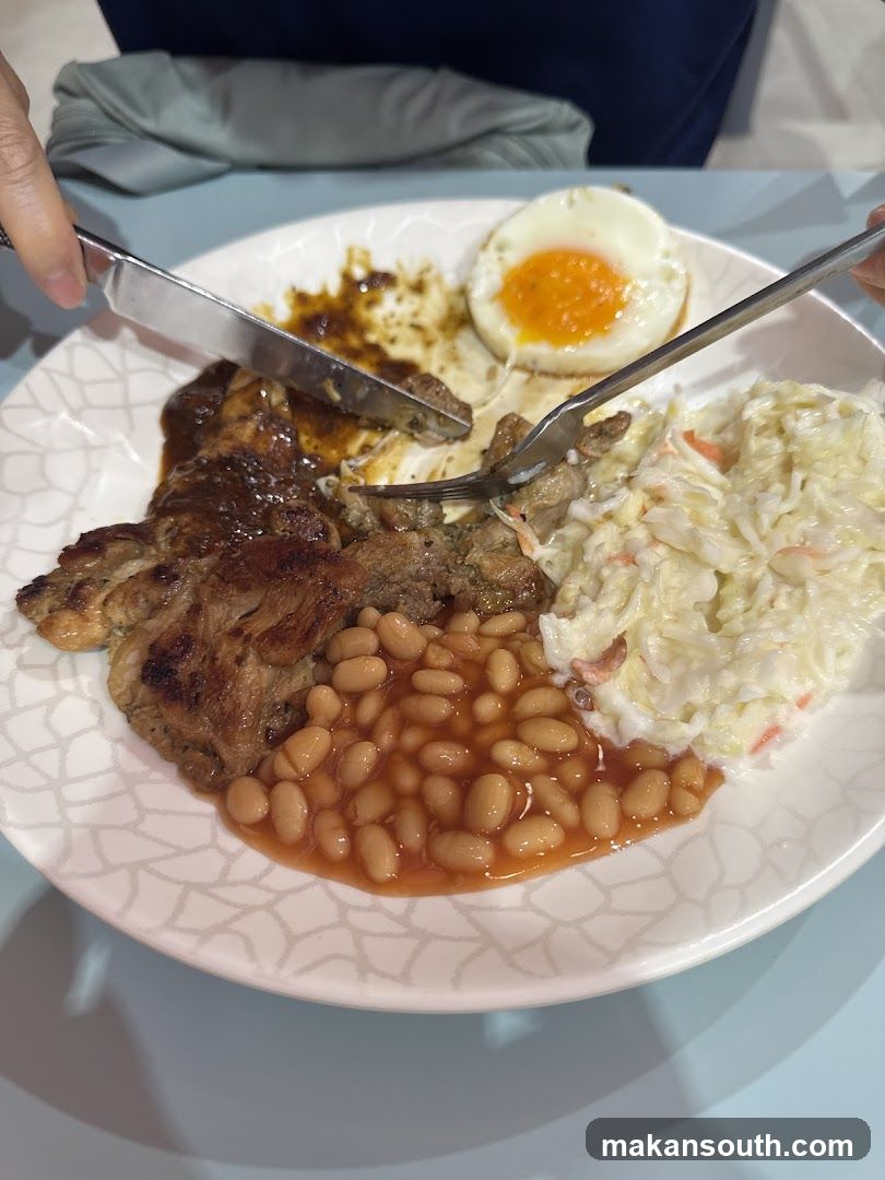 Breakfast Plate with Fried Egg, Baked Beans, Coleslaw and Steak