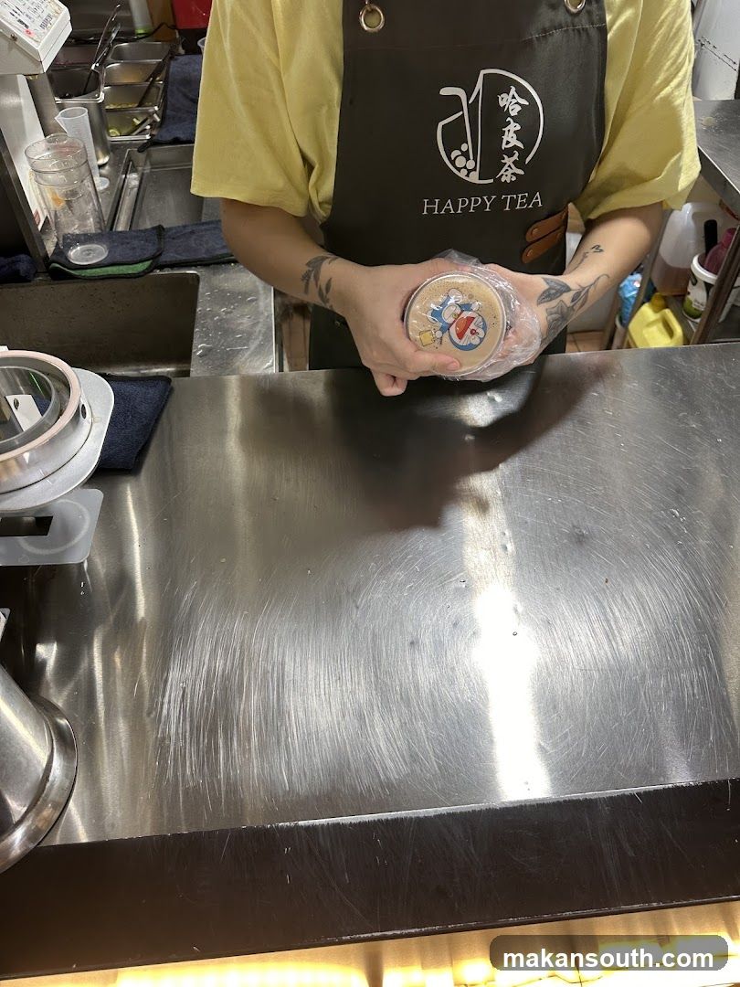 Staff preparing tea at Happy Tea counter