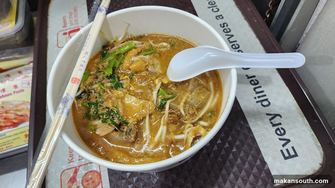 Bowl of Curry Noodles with Chopsticks and Spoon