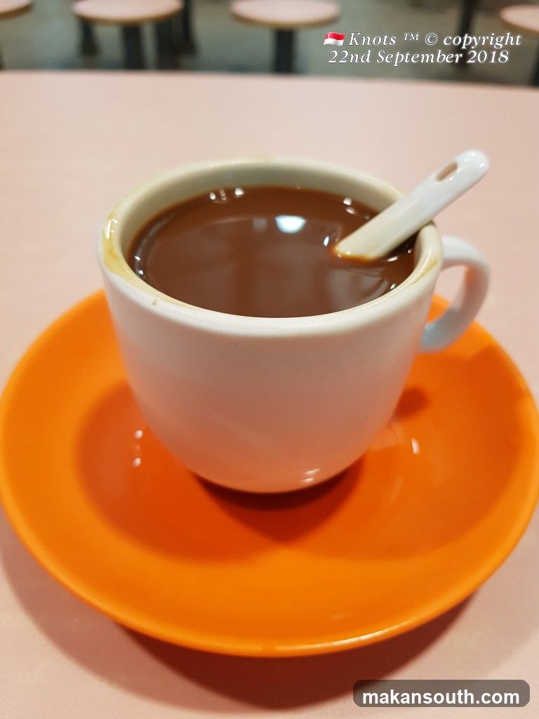 Cup of coffee on orange saucer
