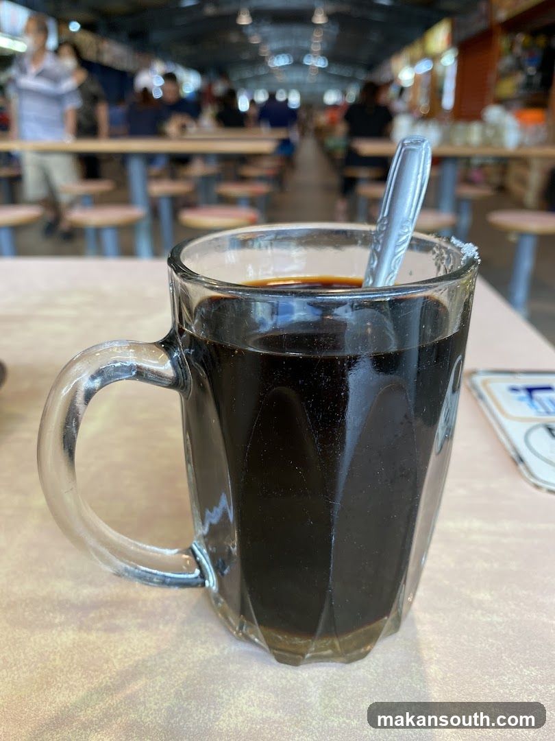 Coffee in a glass mug at a food court