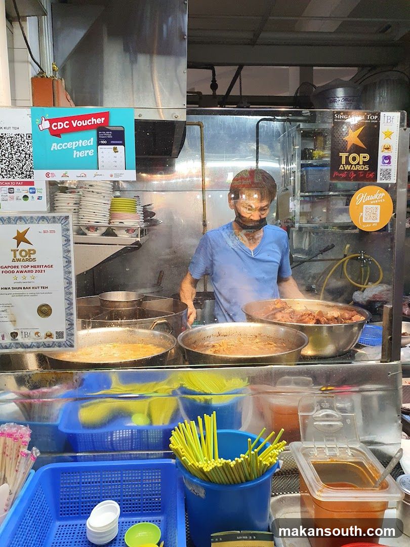 Food Stall Interior with Cook and Awards Display