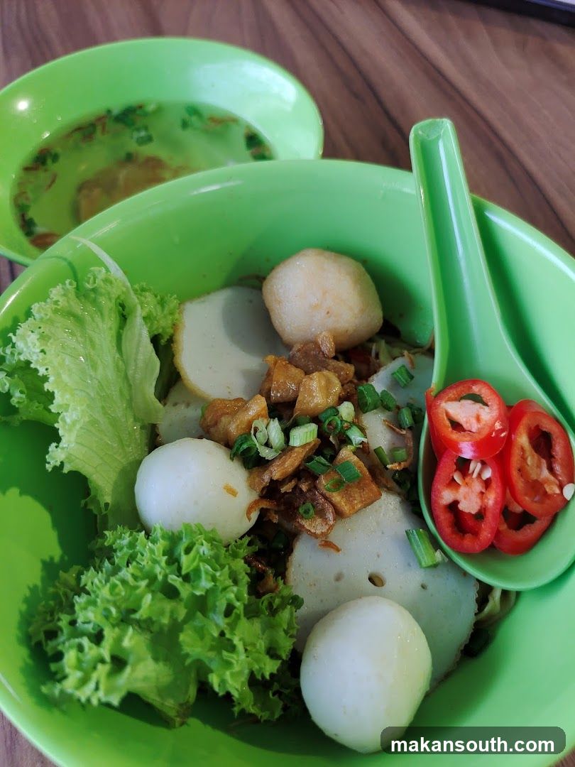 Green Bowl of Food with Fish Balls and Lettuce